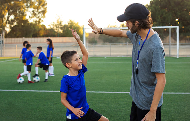Boy High Five with Coach Football